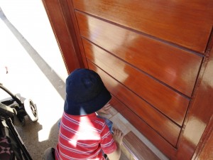 Little hands helping to slide Easter invitations under doors